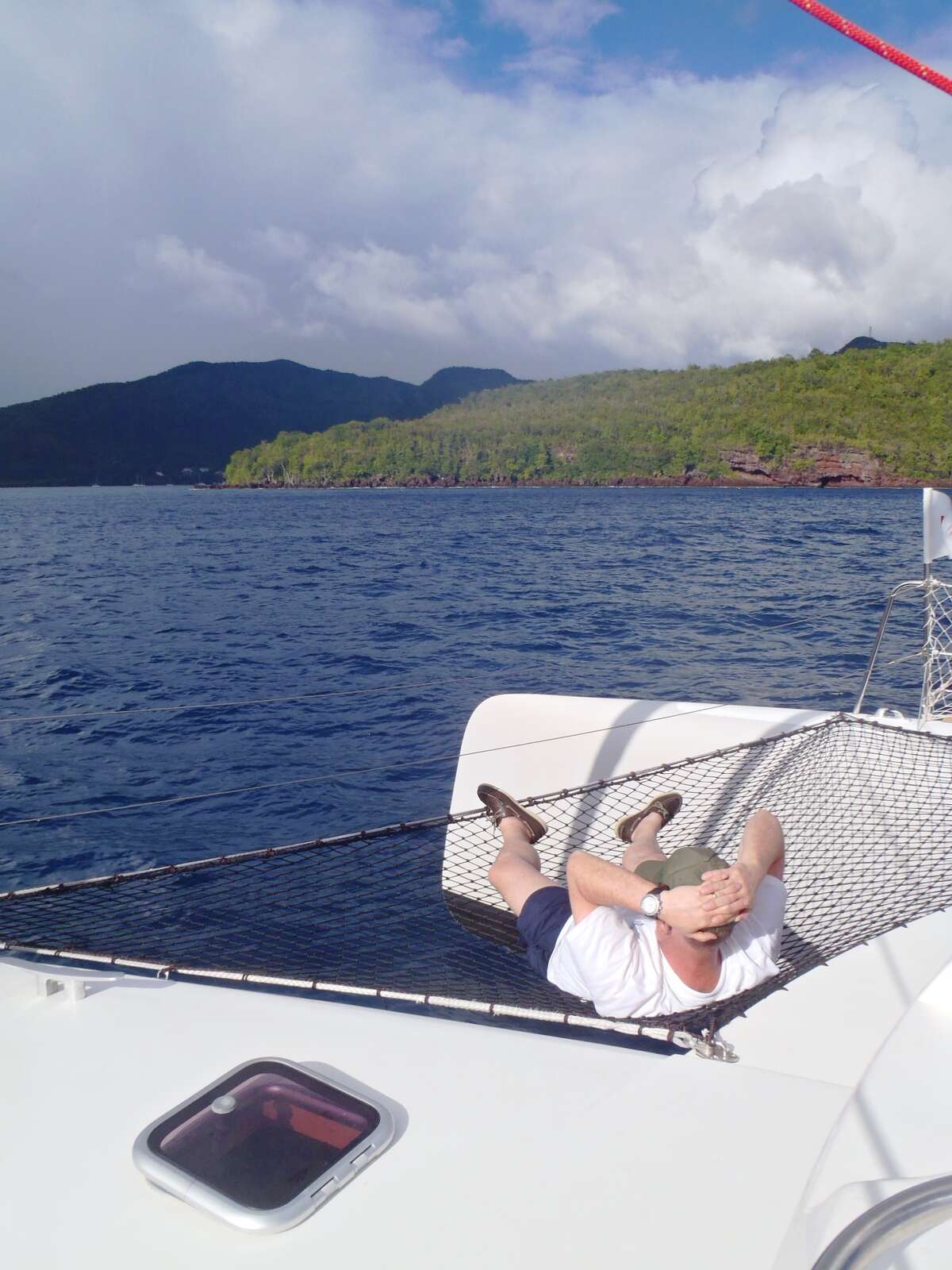 A net in front of the Neel 45 trimaran is the perfect perch for watching the world float by on a sailing vacation in Martinique.