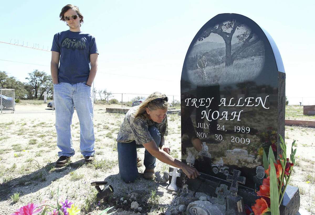 Trey A. Noah's mother, Melodie Noah, and brother, Tyler Noah, pause at Trey's gravesite near Kendalia.