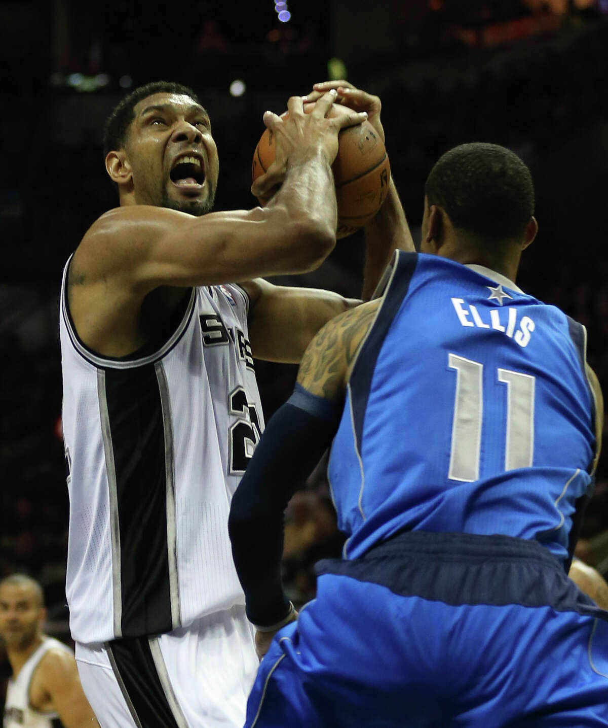 San Antonio Spurs' Tim Duncan drives around the defense of Dallas Mavericks' Monta Ellis during the first half of game one in the first round of the Western Conference Playoffs at the AT&T Center, Sunday, April 20, 2014.