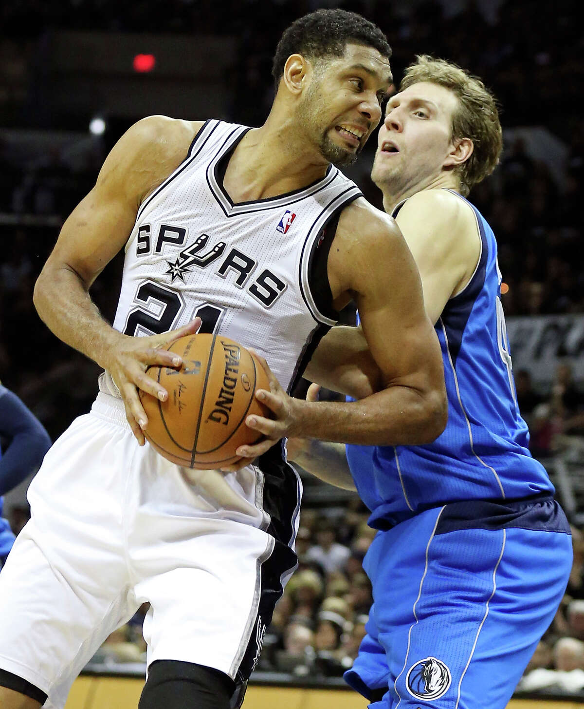San Antonio Spurs' Tim Duncan looks for room around Dallas Mavericks' Dirk Nowitzki during second half action of Game 1 in the first round of the Western Conference playoffs Sunday April 20, 2014 at the AT&T Center. The Spurs won 90-85.
