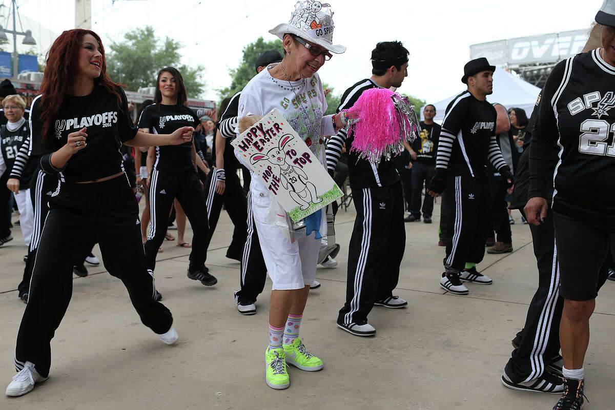 Marylou Rodriguez, center, dances with Team Energy as fans arrive early for the game one of the first round of the Western Conference Finals at the AT&T Center, Easter Sunday, April 20, 2014.