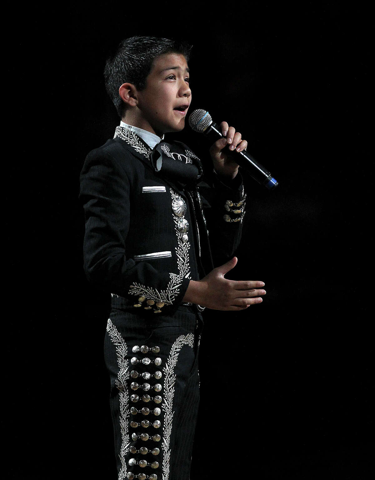 Mariachi singer Sebastian De La Cruz is used to being in the spotlight. Here he is singing the National Athem before the start of game one in the first round of the Western Conference Playoffs between the San Antonio Spurs and Dallas Mavericks at the AT&T Center, Sunday, April 20, 2014.