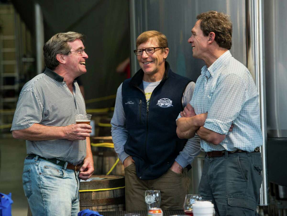 Two Roads Brewing Company executives Brad Hittle and Peter Doering (center and right) talk to George Wyper (left) at the "NorâÄôYeaster" limited edition beer release event at Two Roads Brewing Company, Stratford CT on Saturday, April, 19th, 2014. The brewery was releasing a limited supply of three different beers, Two Roads Krazy Pucker, HenryâÄôs Farm Double Bock Lager Aged in Rye Whiskey Barrels and Urban Funk Wild Ale.
