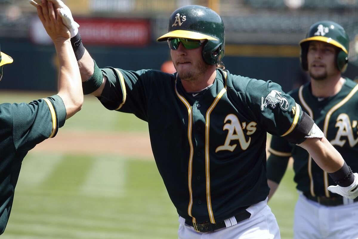 Oakland Athletics' Josh Donaldson celebrates his first-inning two-run homer during a baseball game against the Houston Astros in Oakland, Calif. on Sunday, April 20, 2014. (AP Photo/Mathew Sumner)