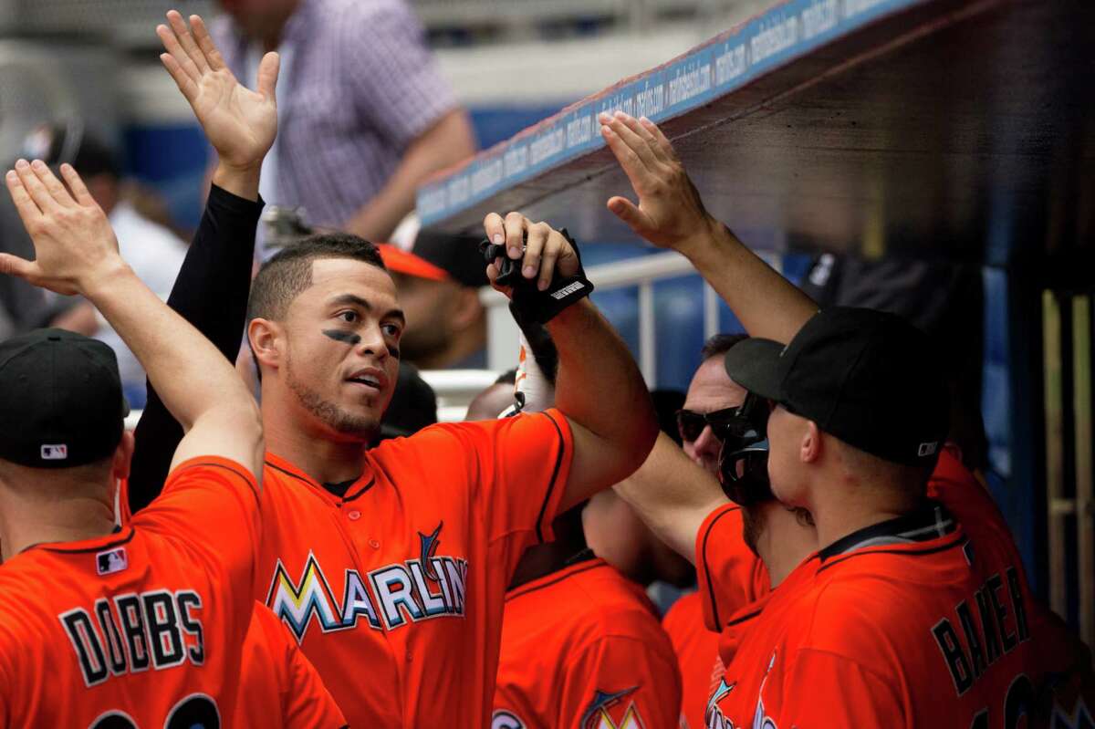 Miami's Giancarlo Stanton receives congratulations after scoring the go-ahead run in the eighth inning.