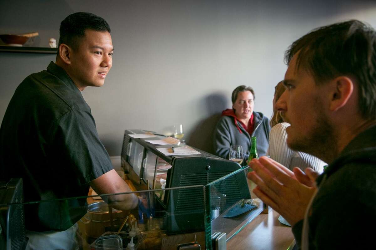 Daniel Realin talks with a customer at the sushi bar at Ichi Sushi in San Francisco.
