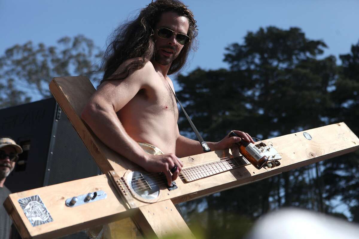 A Hunky Jesus competitor plays his guitar cross while drinking a beer during the Hunky Jesus contest held at the 35th annual Easter Celebration put on by the Sisters of Perpetual Indulgence in Golden Gate Park, San Francisco, Calif. on April 20, 2014.
