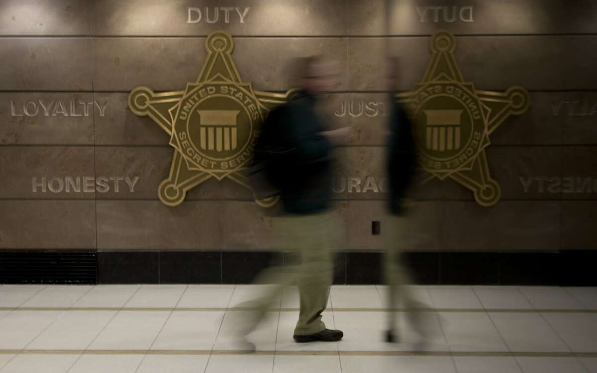 In this Feb. 20, 2014 photo, a man walks through a hall at Secret Service offices in Washington. Secret Service investigators say it could take years to identify the hackers who breached Target's computer systems in December _and even longer to bring them to justice. (AP Photo/Carolyn Kaster)