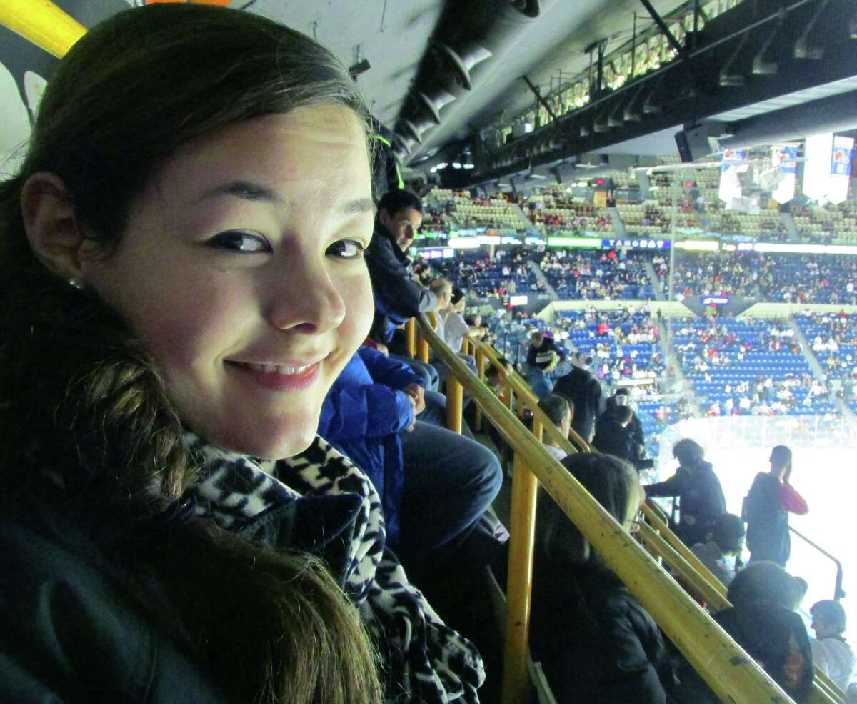 Alex Darinzo enjoys herself while attending an ice hockey game with her host family during a trip by 19 Shepaug Valley Middle/High School students to Quebec, Canada in February 2014 Courtesy of Heidi Edel