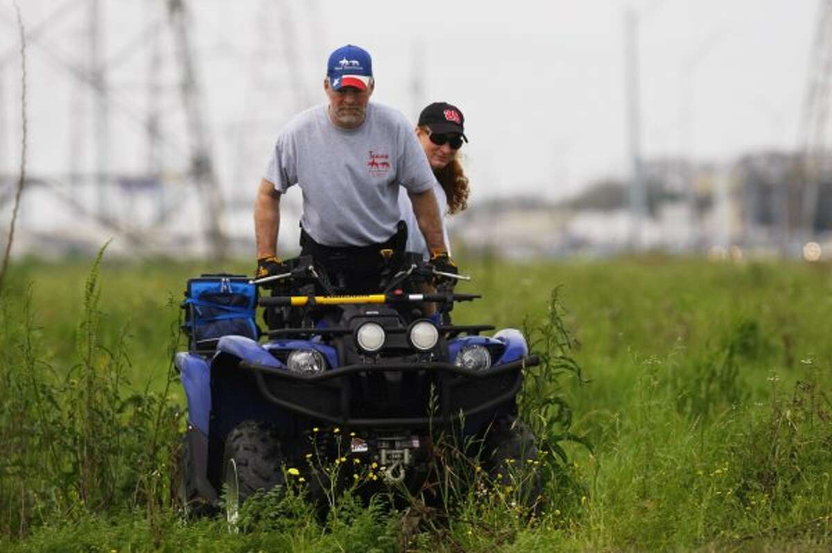 Volunteers with Texas Equusearch use ATVs to search along the Westpark Toll Rd. at Fondren for Kathy Lawson-Arrendondo, 37, who has been missing since Feb. 11. (Johnny Hanson / Houston Chronicle)