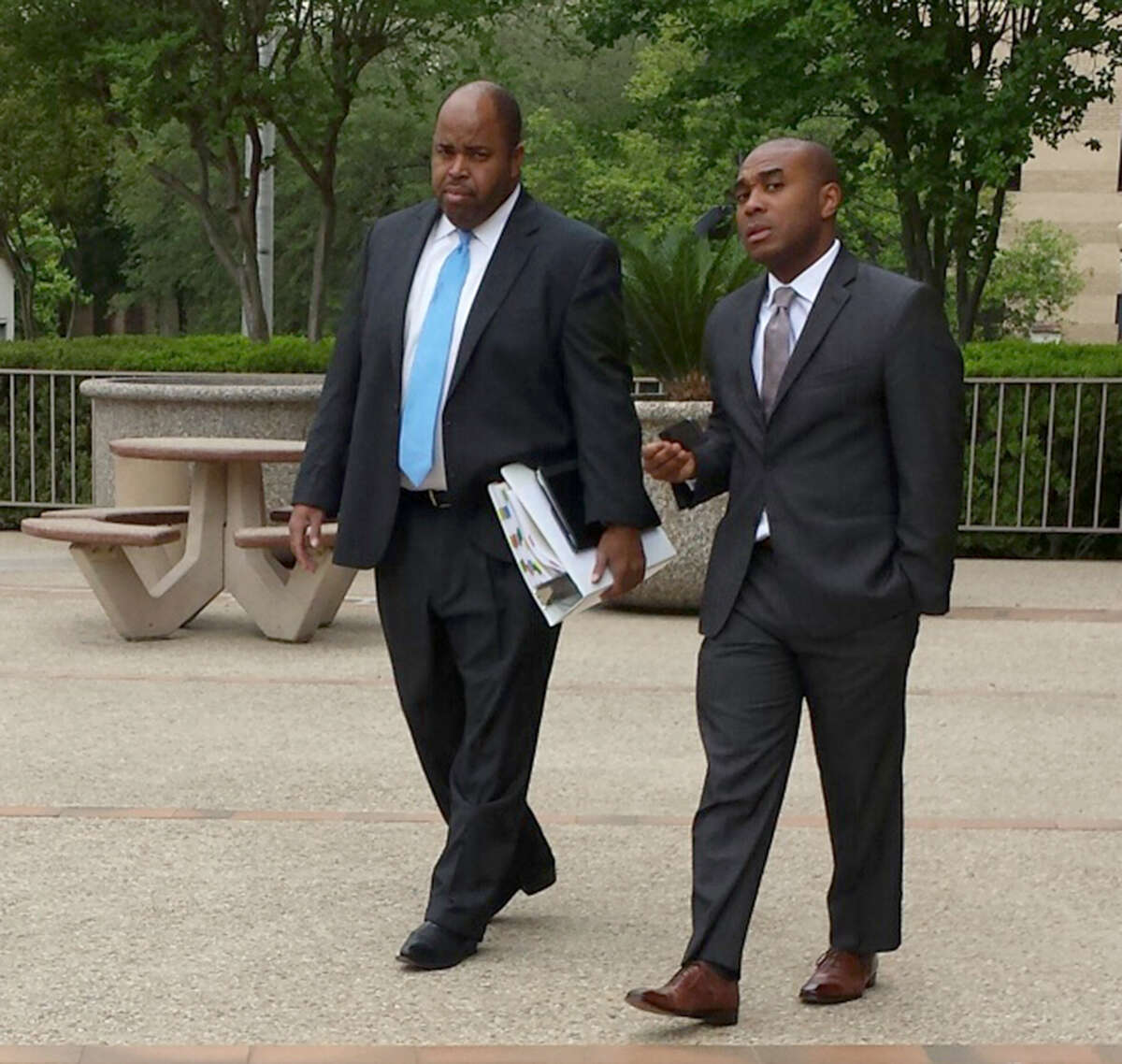 Leonard Roundtree III, right, leaves San Antonio's federal court with his lawyer, Curtis Lilly. Roundtree is on trial on charges that he agreed to help deliver a payment to a hitman his uncle, Alvin Roundtree, allegedly hired to kill his estranged common-law wife. Last June, Alvin Roundtree shot the woman seven times at Joint Base San Antonio -- Fort Sam Houston, but she survived.