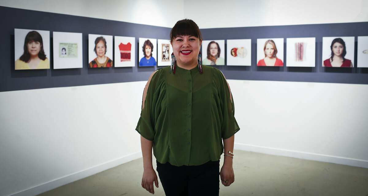 Galeria de la Raza's executive director Ani Rivera is seen with part of "In reference to" works by Alejandra Regalado on Friday, March 28, 2014 in San Francisco, Calif.