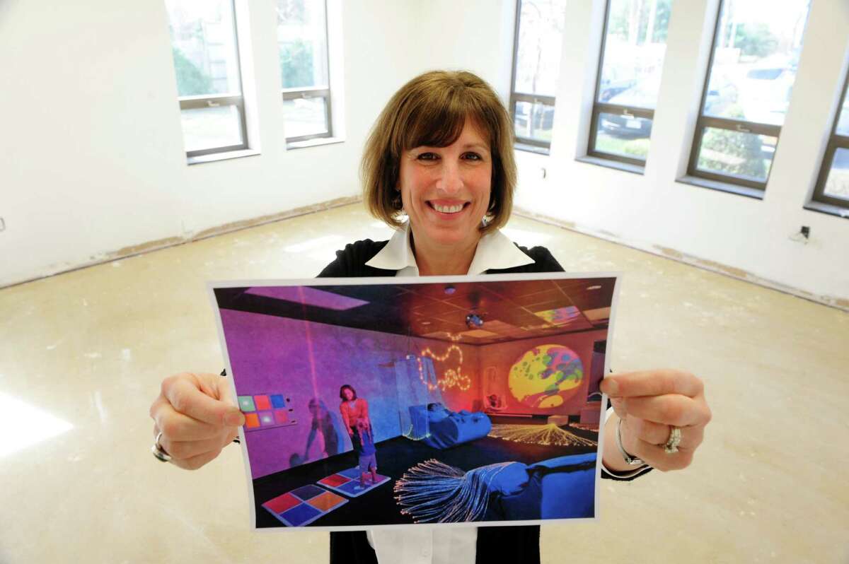 Owner, Sheri Townsend holds a photograph of what the serenity room will look like when completed at the Bizzy Beez Activity Center on Monday, April 21, 2014, in Colonie, N.Y. The serenity room will be a multi-sensory activity room to help children become more centered and focused. The building when finished will be the new location of the Spotted Zebra Learning Center and the Bizzy Beez Activity Center. (Paul Buckowski / Times Union)
