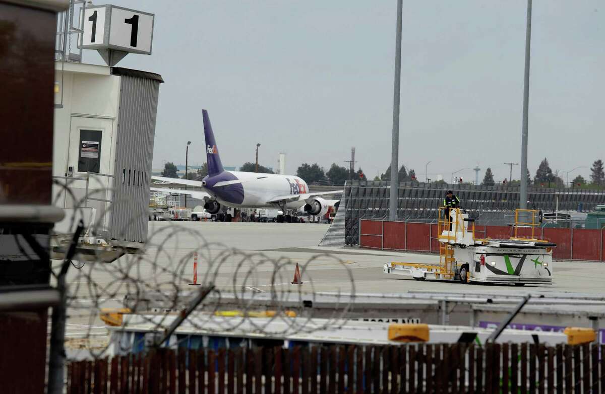 A worker moves equipment near gates used by Hawaiian Airlines at Terminal A of Mineta San Jose International Airport in April.