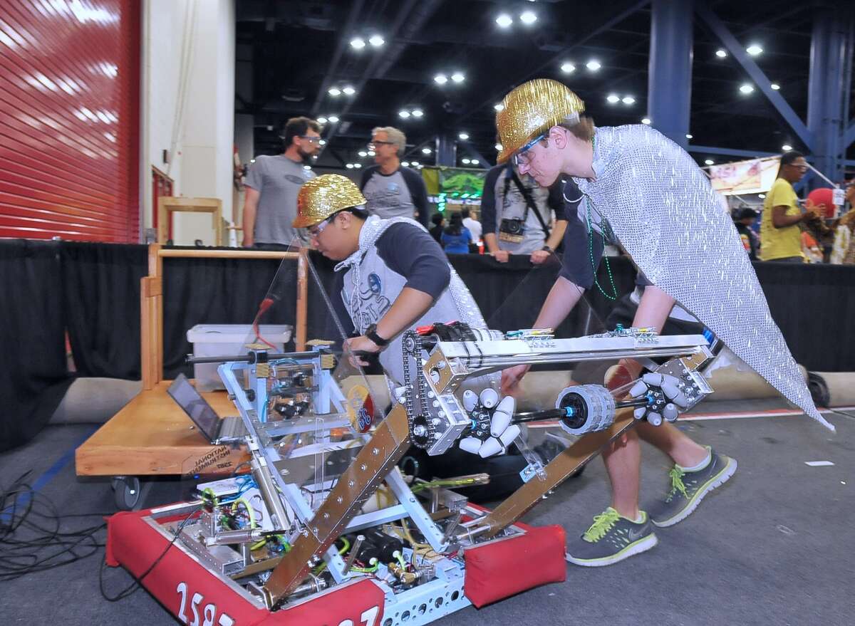 Andrew Nagal, left, makes a few last-minute adjustments to a robot before competing with the Lamar High School team in the VEX Robotics World Championships.
