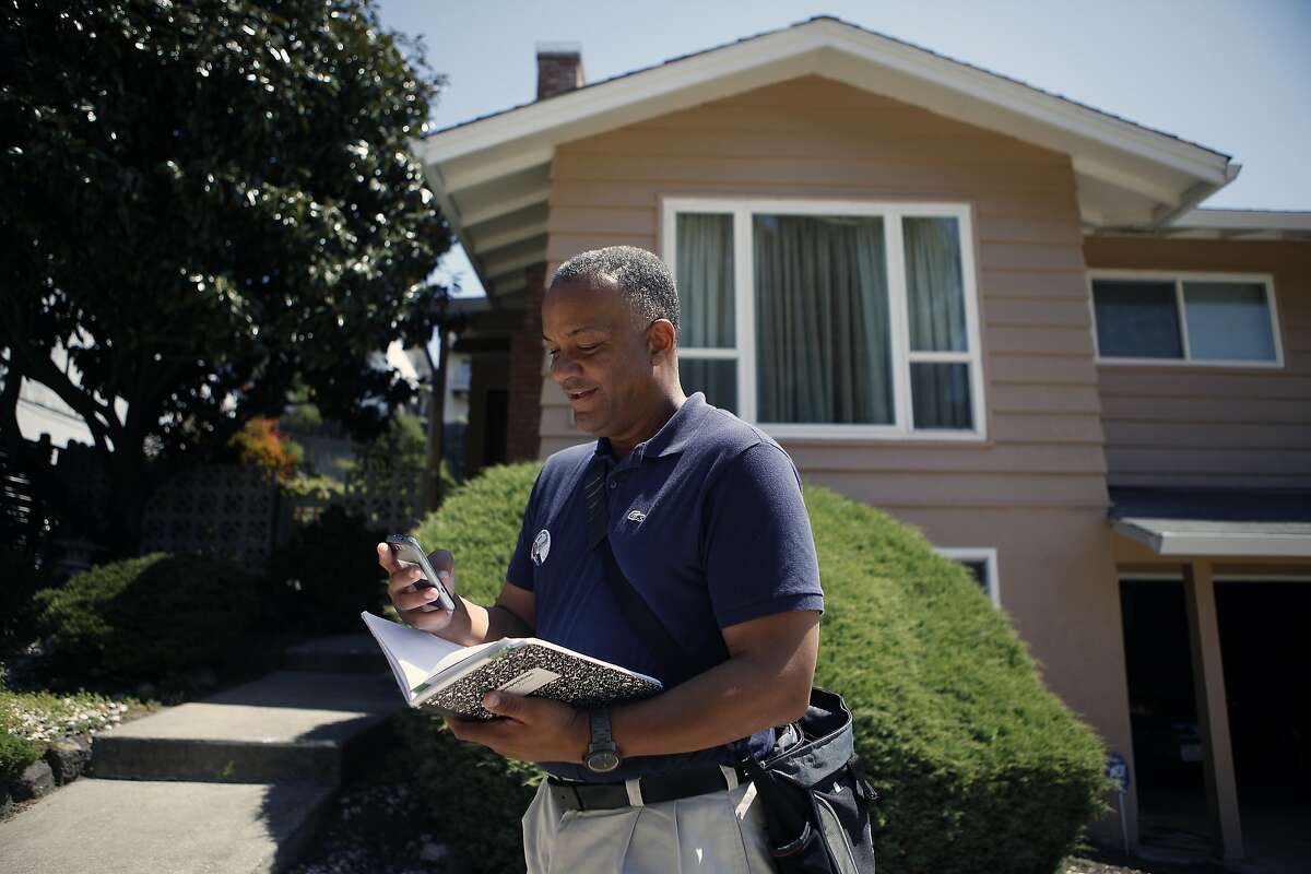 Oakland mayoral candidate Bryan Parker uses the Electionear phone app to help coordinate his campaign as he canvasses an East Oakland neighborhood.