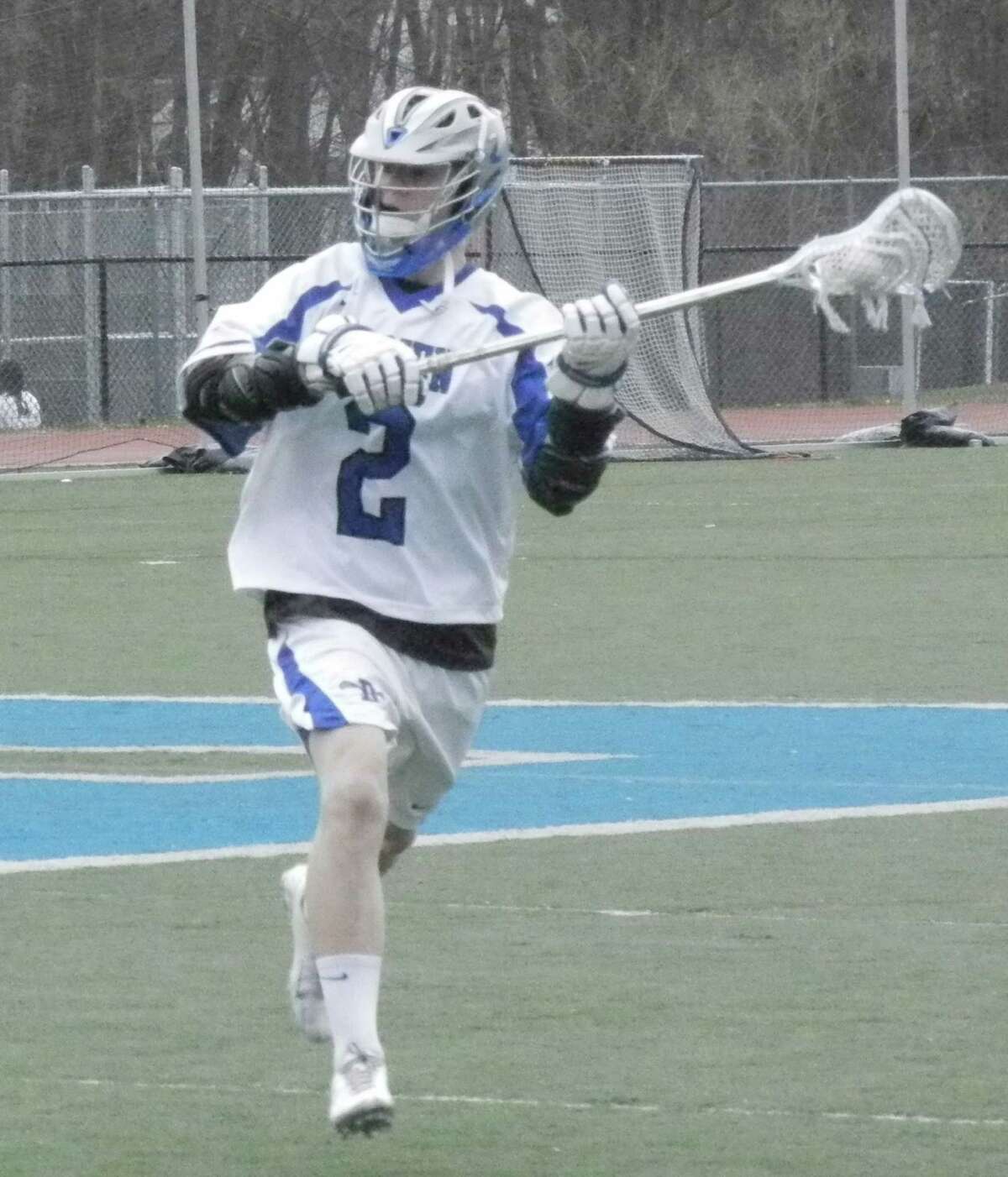 Will Hamernick, of Dairen, has control in an FCIAC boys lacrosse game on Tuesday, April 22. The Blue Wave defeated Fairfield Warde 12-5.
