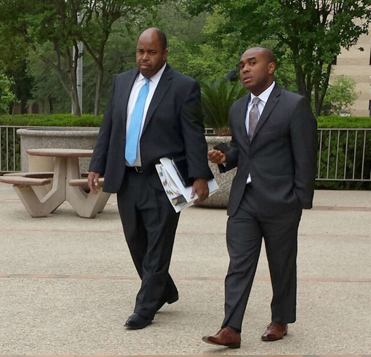 Leonard Roundtree III, right, leaves San Antonio's federal court with his lawyer, Curtis Lilly. Roundtree is on trial on charges that he agreed to help deliver a payment to a hitman his uncle, Alvin Roundtree, allegedly hired to kill his estranged common-law wife. Last June, Alvin Roundtree shot the woman seven times at Joint Base San AntonioÂÃÃ¶Fort Sam Houston, but she survived.