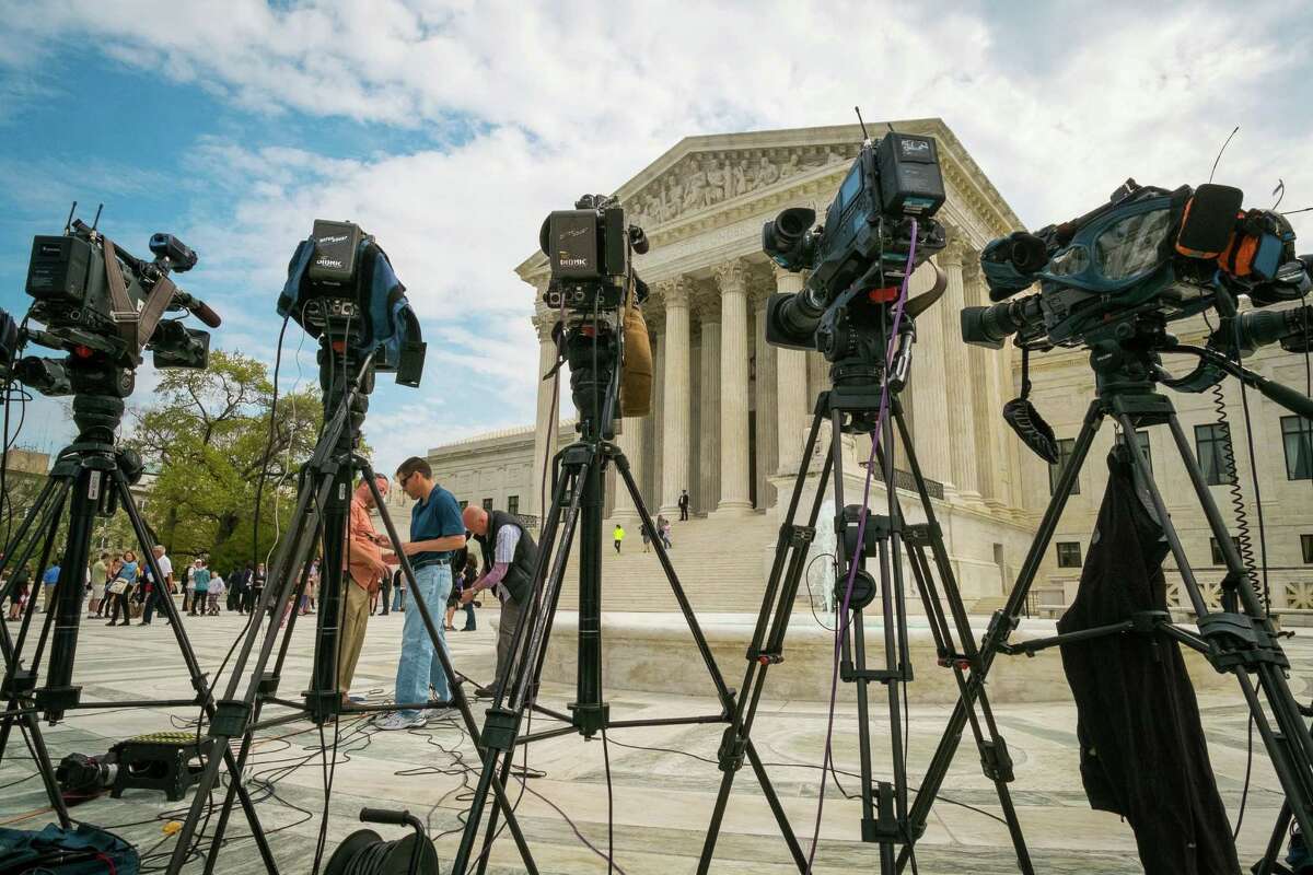 Videojournalists set up outside of the Supreme Court in Washington, Tuesday, April 22, 2104. The court is hearing arguments between Aereo, Inc., an internet startup company that gives subscribers access to broadcast television on their laptops and other portable devices and the broadcasters. (AP Photo/J. David Ake)