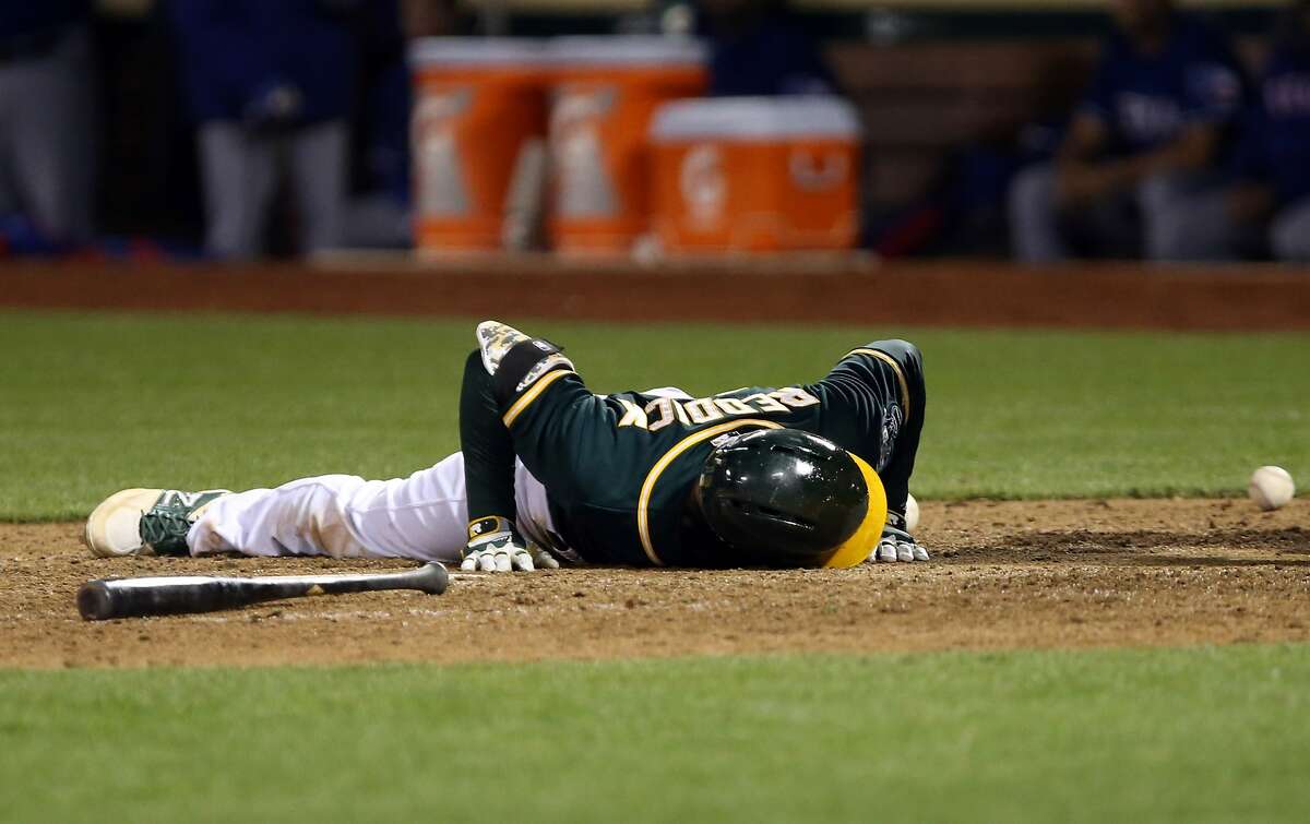 Apr 22, 2014; Oakland, CA, USA; Oakland Athletics right fielder Josh Reddick (16) on the ground after being hit by pitch against the Texas Rangers during the eighth inning at O.co Coliseum. Mandatory Credit: Kelley L Cox-USA TODAY Sports