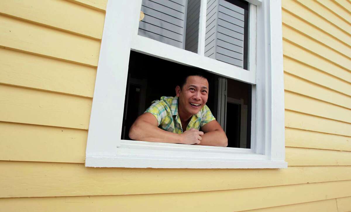 Dominic Yap bought this home in the First Ward in 2013, anxious to try "respectful restoration" rather than demolition. In this photo he looks out the window of the home he purchased from Gloria and Paul Perez. The job is finished...and in one day there was a contract on the home. April 4, 2014, in Houston. ( James Nielsen / Houston Chronicle )