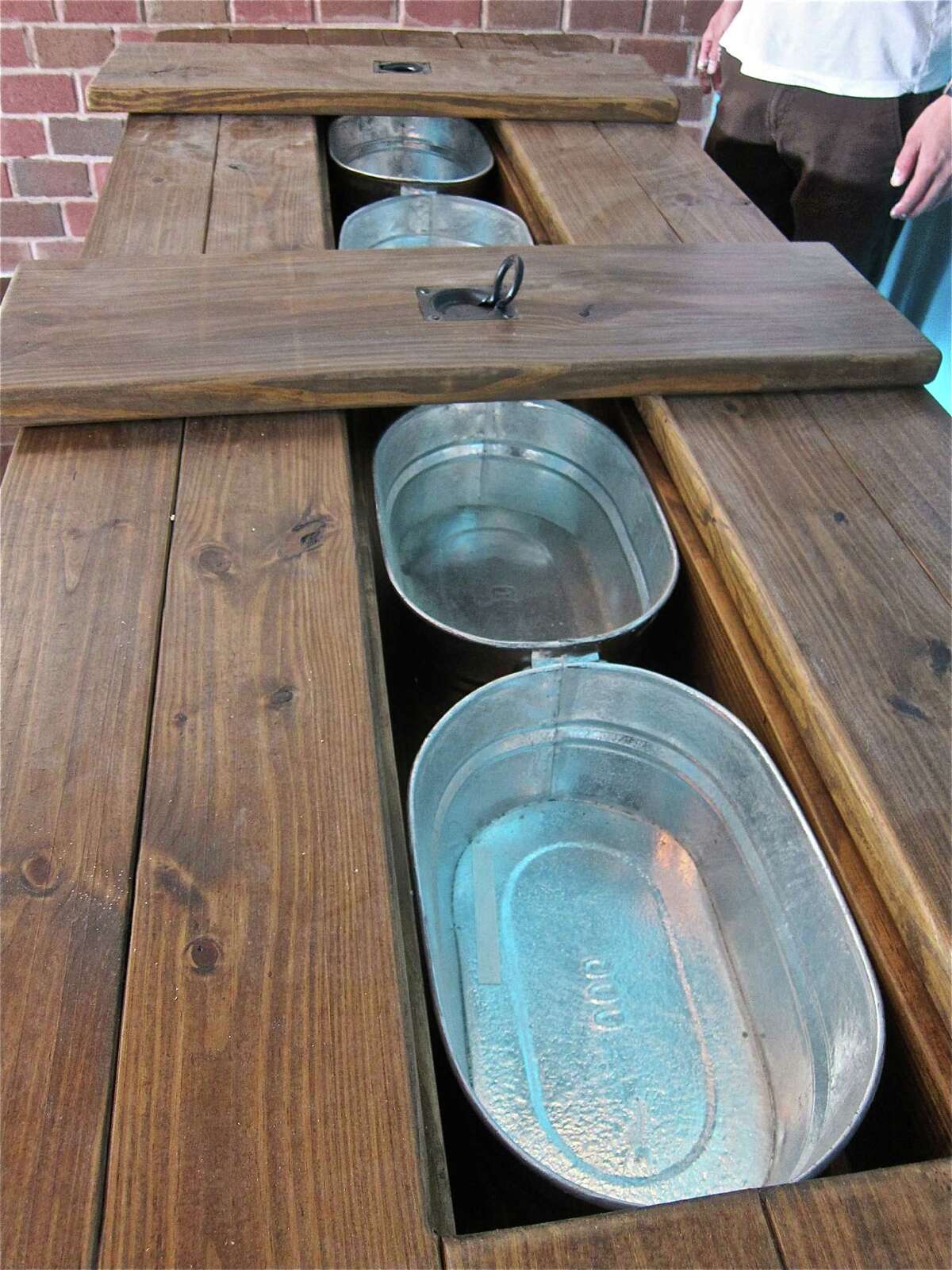 Custom picnic table for large parties at Lillo & Ella, with wells for ice, beverages or utensils.