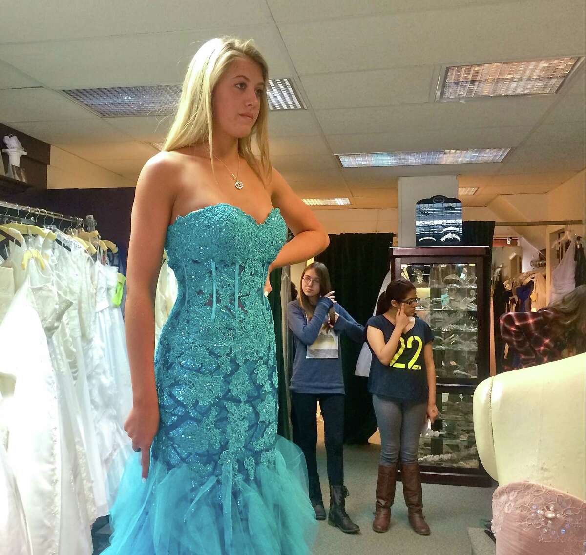 Mandy Thompson, a senior at New Fairfield HIgh School, tries on a mermaid-style gown at Occasions Bridal Shop in Bethel.