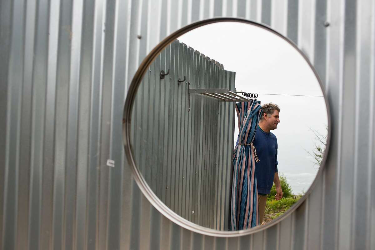 Stewart's Point store has set up a number of "glamping" tents overlooking the ocean with luxurious bedding and wood fireplace for heat on the coast of Sonoma County, Calif., Monday, April 21, 2014. Here owner Charlie Richardson, who did most of the work himself, is reflected in a mirror in the outdoor couple's shower.