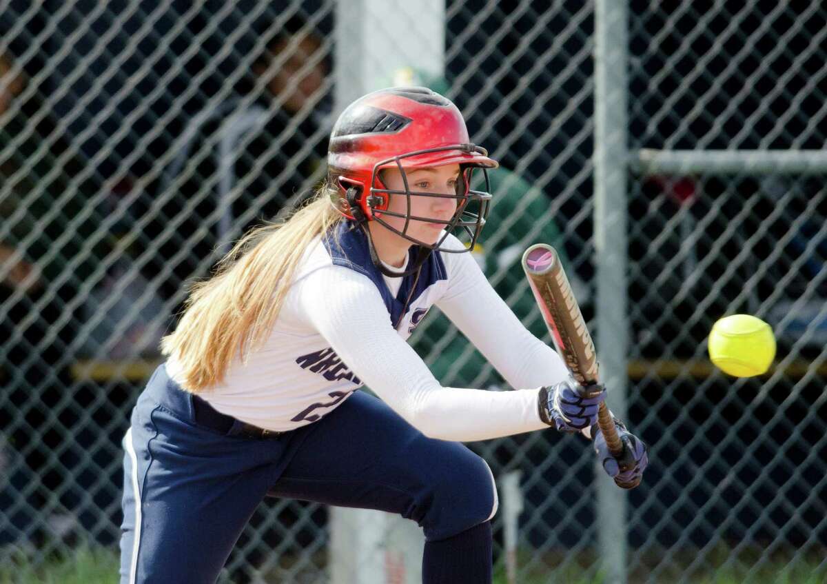 Staples' Lily Tofel (23) bunts the ball during the softball game against Trinity Catholic High School at Wakeman Field in Westport on Wednesday, Apr. 23, 2014.