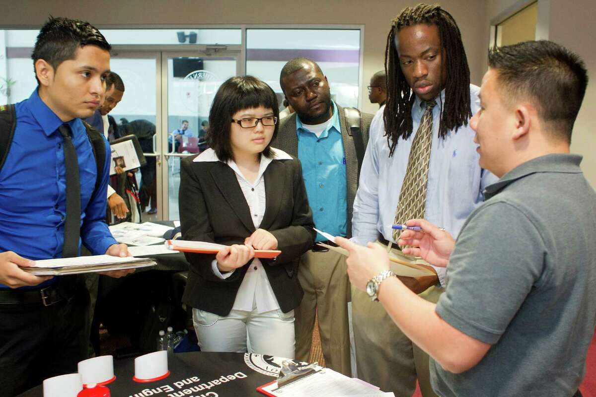 Bach Le, right, a human resources specialist with the city of Houston, talks with Texas Southern University students during a career fair this week. The U.S. class of 2014 has it better than students who graduated a year ago, college placement officers say. ﻿