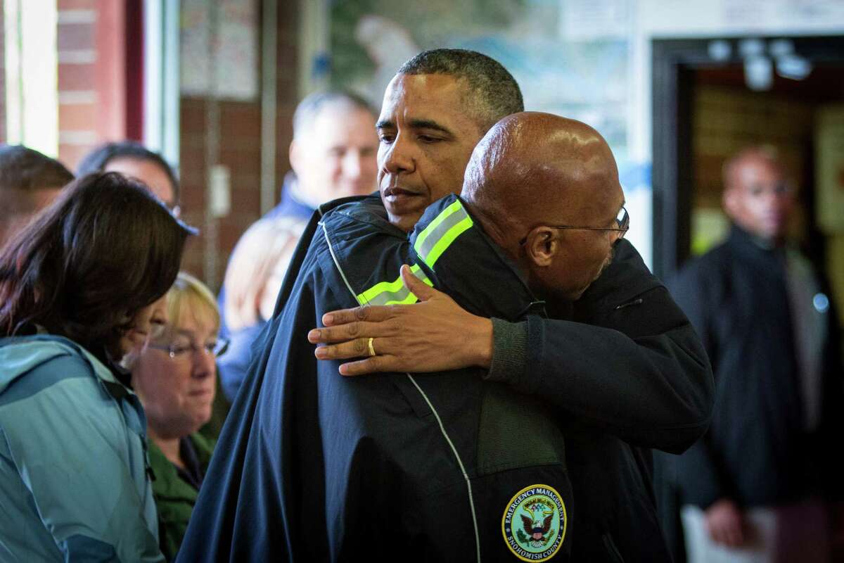 President Barack Obama hugs County Executive John Lovick as Obama visits the Oso Fire Station to speak with rescuers near the scene of last month's deadly Oso mudslide. Photographed on Tuesday, April 22, 2014.
