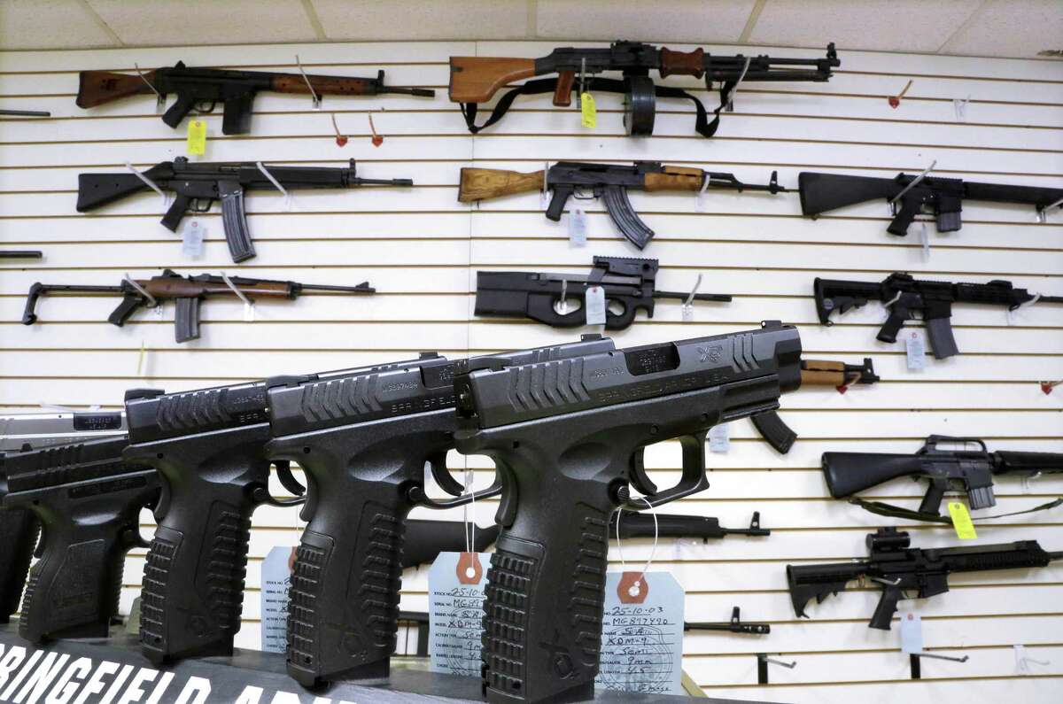 ADVANCE FOR USE SUNDAY, DEC. 22 AND THEREAFTER - FILE - In this Jan. 16, 2013 file photo, assault weapons and hand guns are seen for sale at Capitol City Arms Supply in Springfield, Ill. Illinois became the last state in the nation to allow the concealed carry of firearms after a federal court ruling and lengthy negotiations in the General Assembly. The story was voted as one of the top 10 stories in Illinois for 2013.