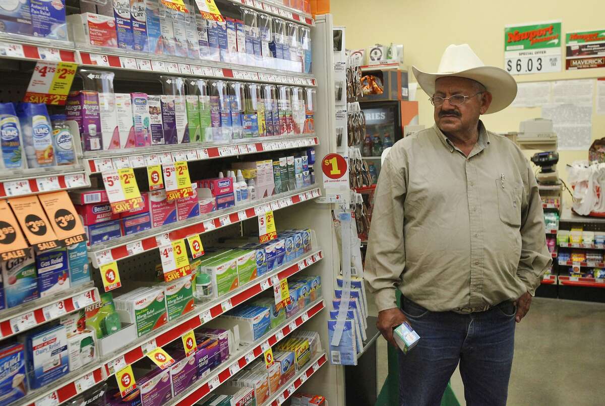 Jose Pineda Rivas, 61, holds Alka Seltzer for his stress-induced upset stomach as he waits for his wife Maria Callejas, 43, to find what she needs April 10, 2014 at the Family Dollar store in Mendota.