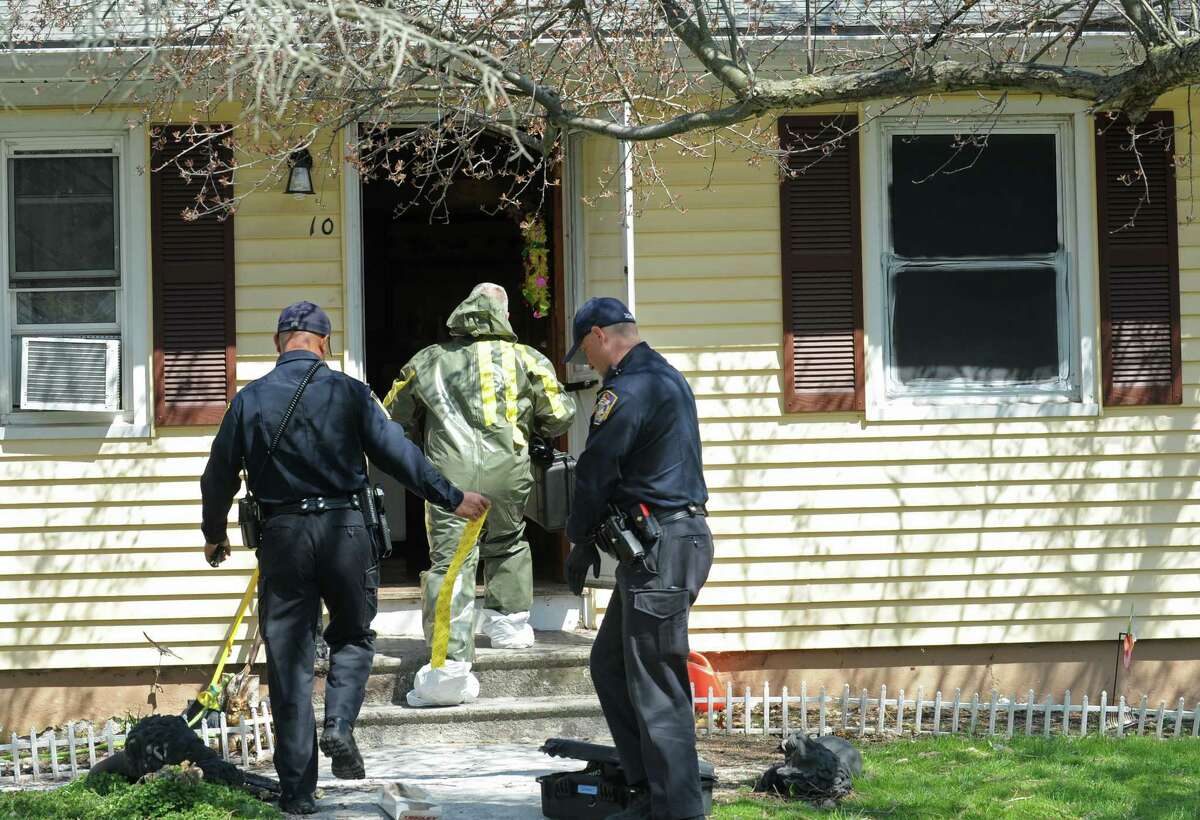 Detective Nihill enters the scene at 10 Eleanor Road in Seymour, Conn. in a hazmat suit on Friday, April, 25, 2014. Arthur Gauvin was arrested after his sister Nancy was found being held in the house.The window to the right is painted black and is where Nancy was allegedly held.
