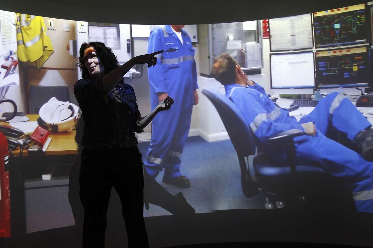 Samantha Soma, UX Research and Community Lead, shows off the "holodeck" during a press tour around GE's first innovation center April 24, 2014 at the GE Global Software Center in San Ramon, Calif. The 25 foot room isn't exactly 360 degrees, but it offers a nearly 360 degree view of moving images and still images along with audio recorded with a 360 GoPro rig to provide GE employees with an immersive experience. The hope is that in immersing designers in the experience of the people using GE technology and equipment, it will create empathy and thus foster better problem-solving.