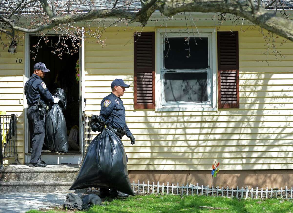 Police officers remove bags filed with items taken from the scene at 10 Eleanor Road in Seymour, Conn. on Friday, April, 25, 2014. Arthur Gauvin was arrested after his sister Nancy was found being held in the house.