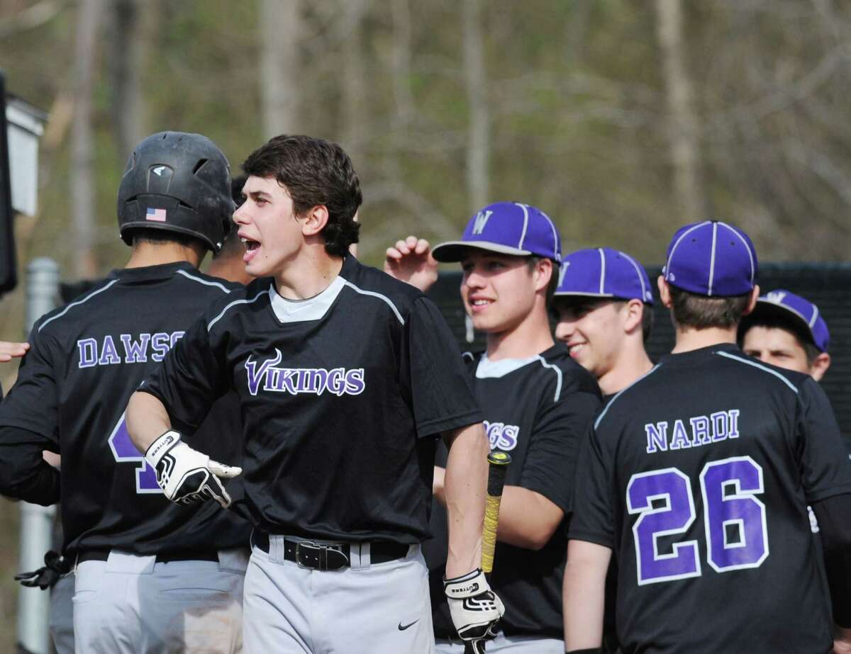 Westhill celebrates as a run is scored during the school baseball game between Greenwich High School and Westhill High School at Greenwich, Friday afternoon, April 25, 2014.