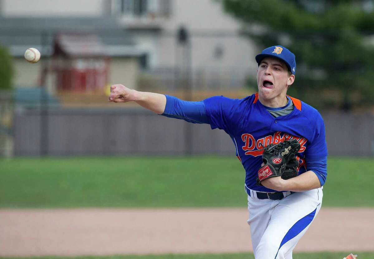 Danbury's Dan Clancy sticks out his tongue as he pitches during Friday's baseball game at Stamford High School on April 25, 2014.