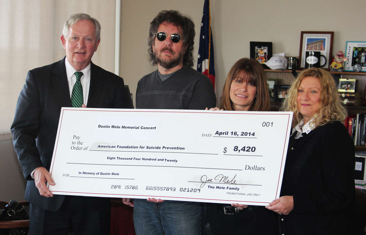 On April 16 the parents of Dustin Mele, who died at age 28 in March 2013, presented a check to the American Foundation for Suicide Prevention?s Capital Region Area Director Laura Marks at Troy City Hall. The check represents donations raised at the Dustin Mele Memorial Concert event on March 30. Shown are Deputy Mayor Peter Ryan, Joe Mele, Marks and Patti Quade, Dustin's mother. (Submitted photo)