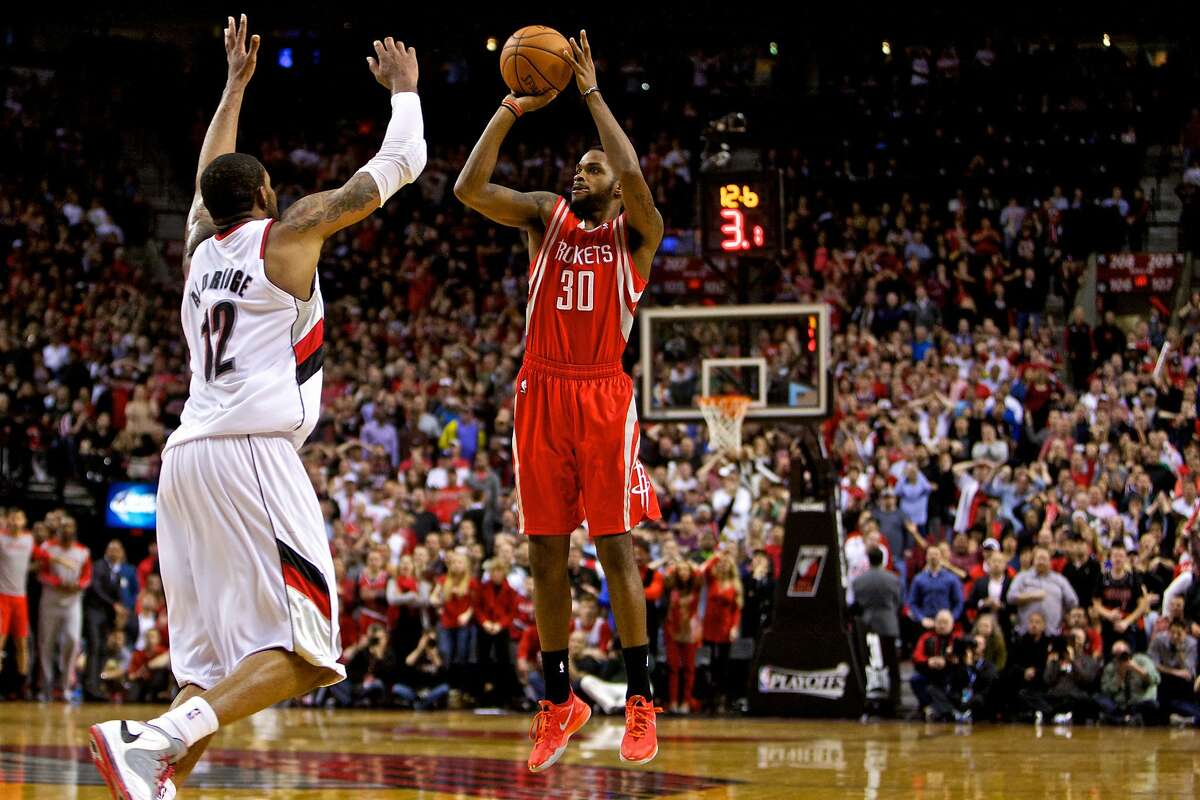 Apr 25, 2014; Portland, OR, USA; Houston Rockets guard Troy Daniels (30) makes a three point basket over Portland Trail Blazers forward LaMarcus Aldridge (12) with 12 seconds left in overtime to win game three of the first round of the 2014 NBA Playoffs at the Moda Center. Mandatory Credit: Craig Mitchelldyer-USA TODAY Sports