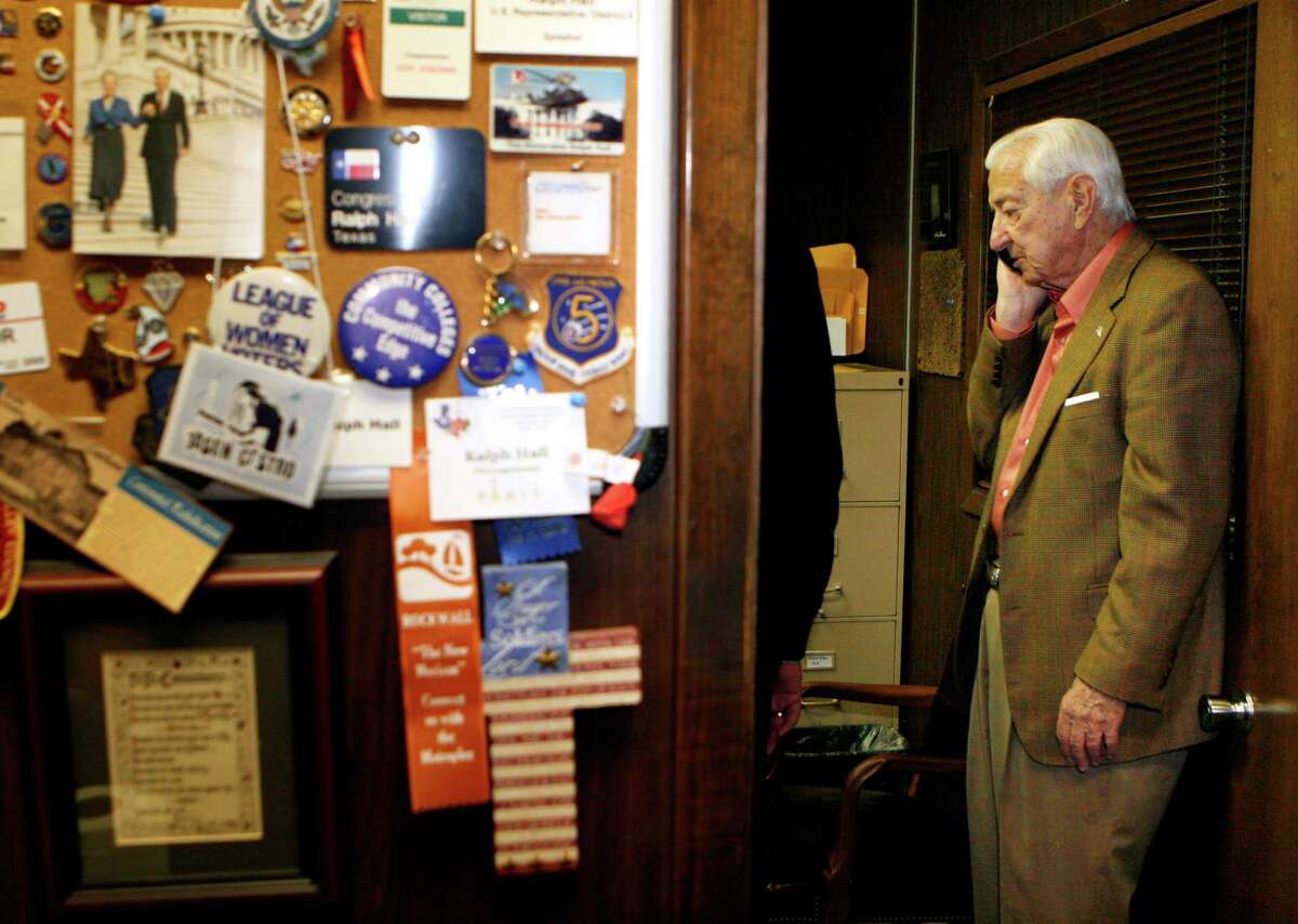 GOP Rep. Ralph Hall takes a call during primary election night in Rockwall. He's seeking his 18th term in Congress but faces John Ratcliffe in a runoff.