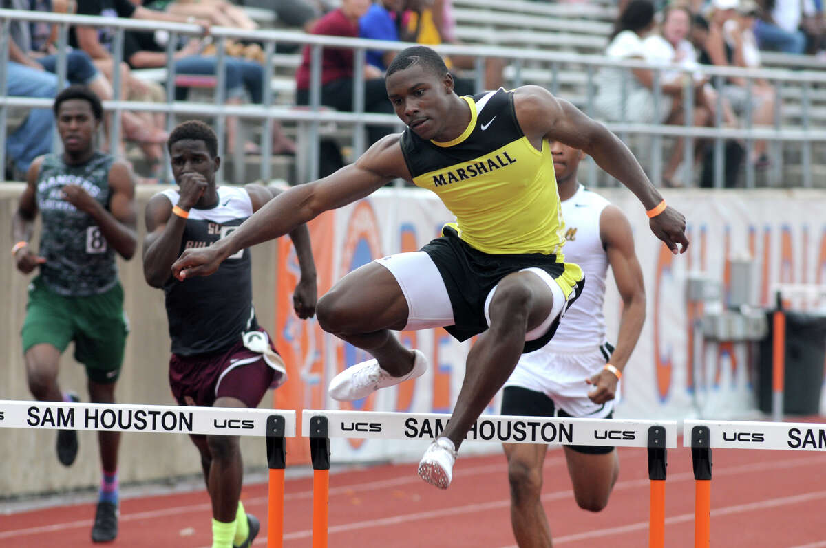 Fort Bend Marshall junior Kendall Sheffield pushes to the finish line to win the Boys 300 Meter Hurdles at the 2014 Region III-4A Track & Field Championship at Bowers Stadium on the campus of Sam Houston State University in Huntsville on Saturday.