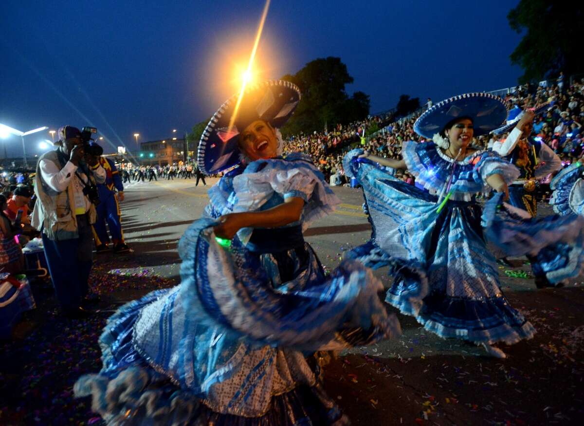 Folklorico dancers perform during the Fiesta Flambeau parade on Saturday, April 26, 2014.