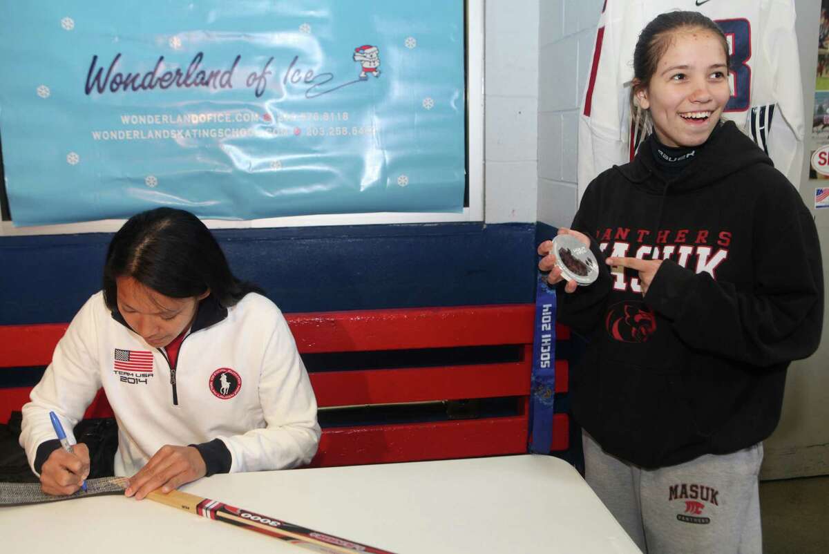 Olympic silver medalist Julie Chu meets and signs a stick for Michelle Vaidere-Silovs, 14, of Monroe, and other fans at the Bridgeport Wonderland of Ice on Sunday, April 27, 2014.