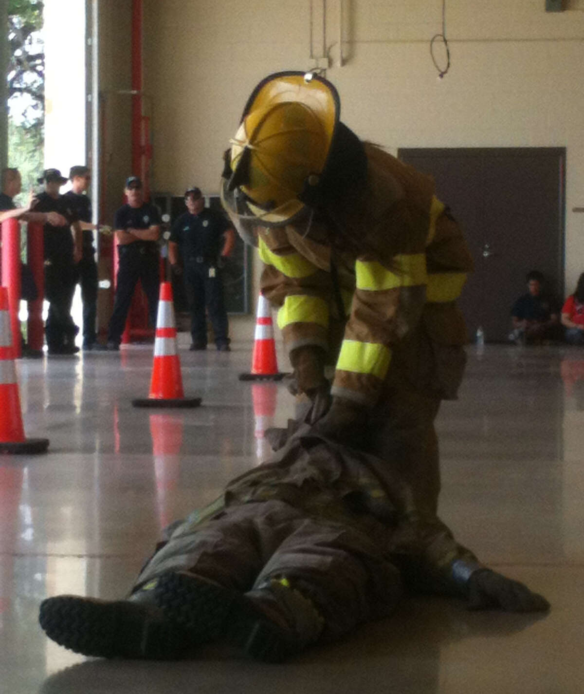 A Fire Explorer does a simulated person-down drag in the 2013 Fire Exploring competition.