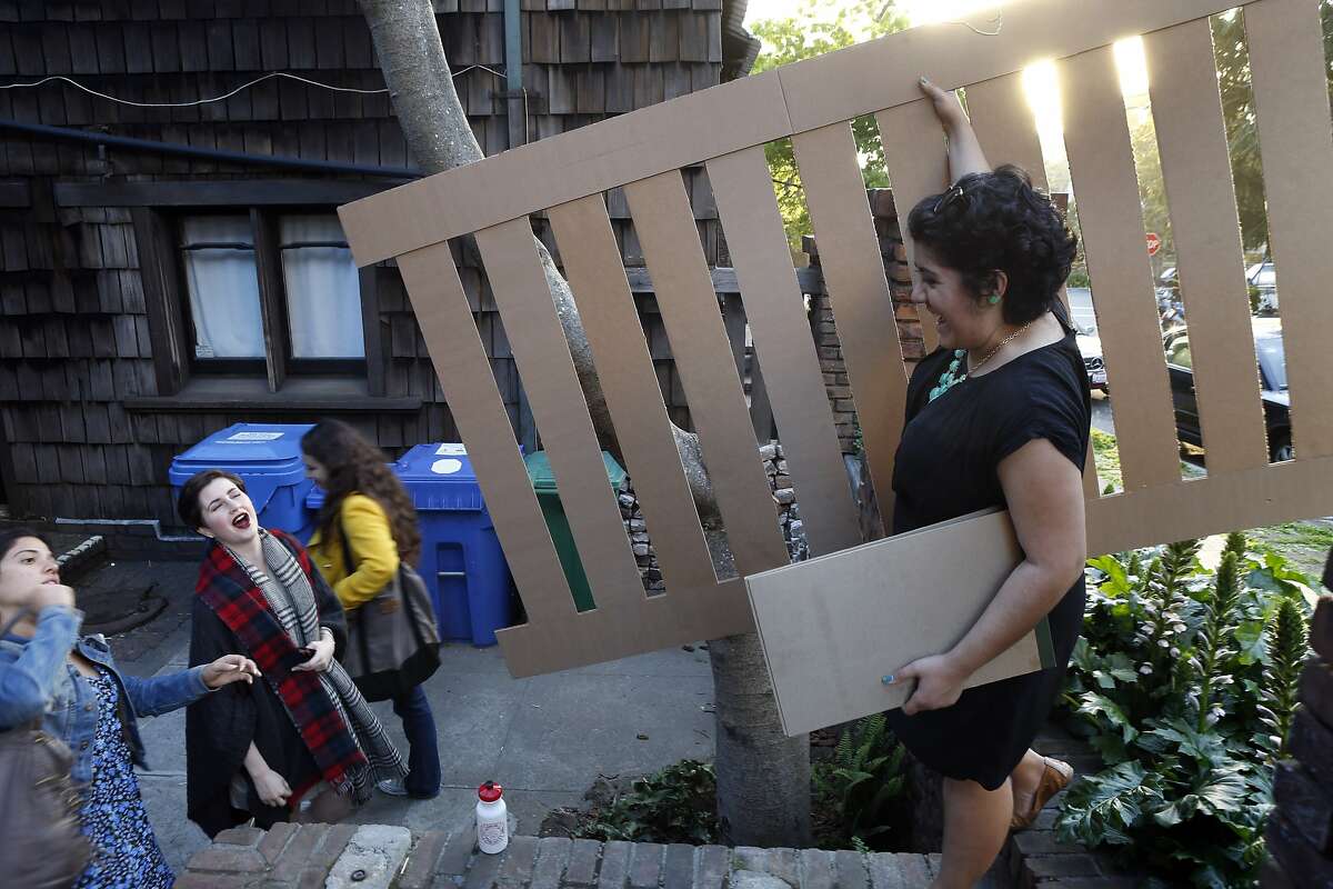 Architecture student Lauren Aguilar holds a scale mockup of a fence section to be restored at the Thorsen House on Tuesday, April 15, 2014, in Berkeley, Calif. A student-taught class works at Thorsen House, a famous Berkeley house originally designed and built by the Greene & Greene, which is now home to the Sigma Phi fraternity. The fraternity works with classes from the architecture department and the city for preservation and necessary repairs.
