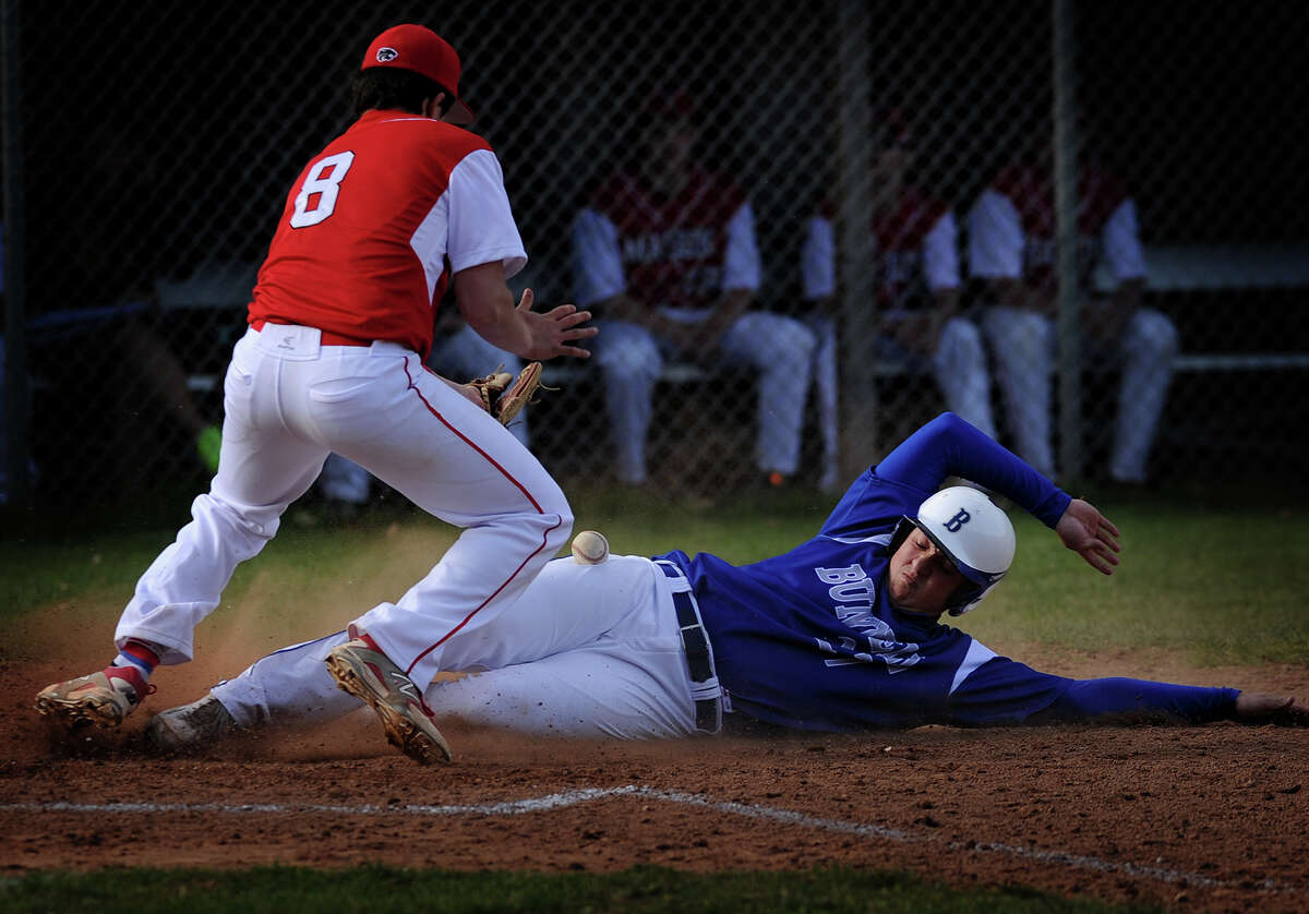 Bunnell's Justin Lasko scores from third on a wild pitch as Masuk pitcher Paul Marchese attempts to handle the throw in the third inning of their baseball game at Masuk High School in Monroe, Conn. on Monday, April 28, 2014.