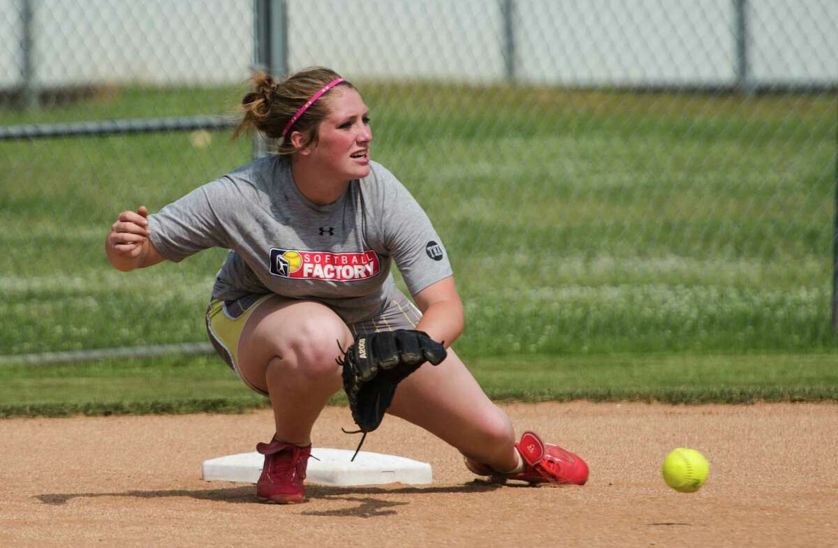 Bridge City's Kasey Frederick kneels for a ground ball during Monday's practice. The Bridge City High School softball team practiced Monday afternoon. The previous Friday's win marked Coach Miste Henderson's 200th career win. Photo taken Monday, 4/28/14 Jake Daniels/@JakeD_in_SETX