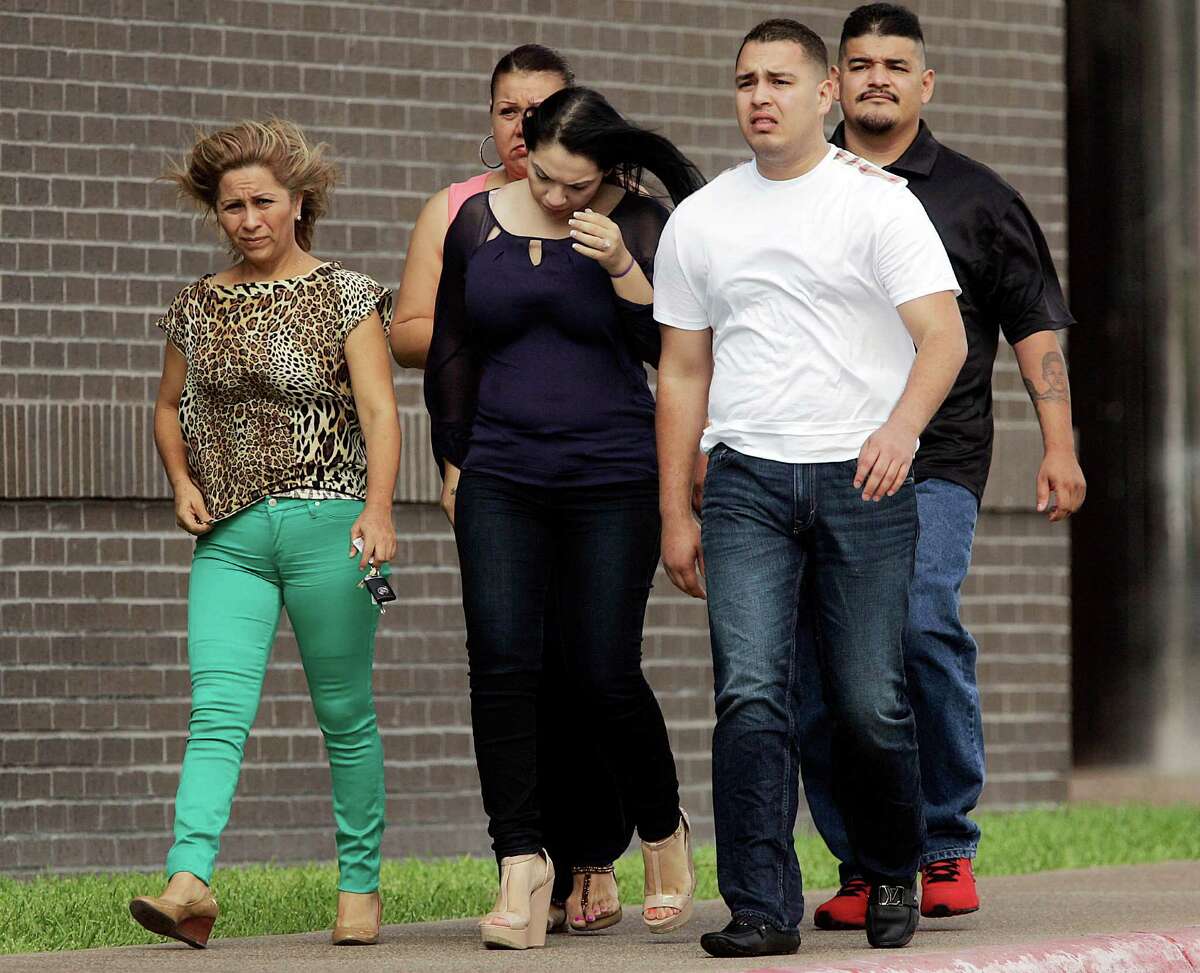 Fernando Guerra Jr., in white, leaves the Federal Courthouse in McAllen, Texas on Wednesday, May 29, 2013, after his arraignment was postponed. Five former South Texas law enforcement officers, including the son of a local sheriff Fernando Guerra Sr., pleaded guilty to drug charges in McAllen on Wednesday.