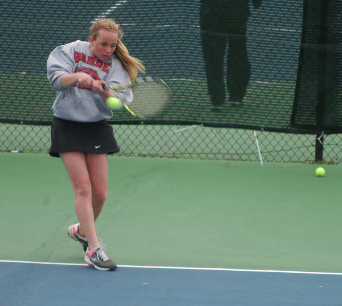 Fairfield Warde's Mackenzie Burns sends a backhand shot toward Fairfield Ludlowe's Daria Efimov on Tuesday, April 29 in an FCIAC girls tennis match at Ludlowe. Burns lost 6-3, 6-1 as the Falcons won the match 5-2 to remain undefeated.